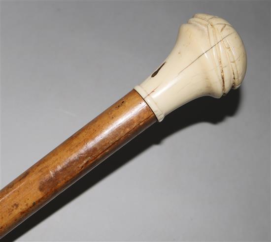 An ivory scarab carved walking stick